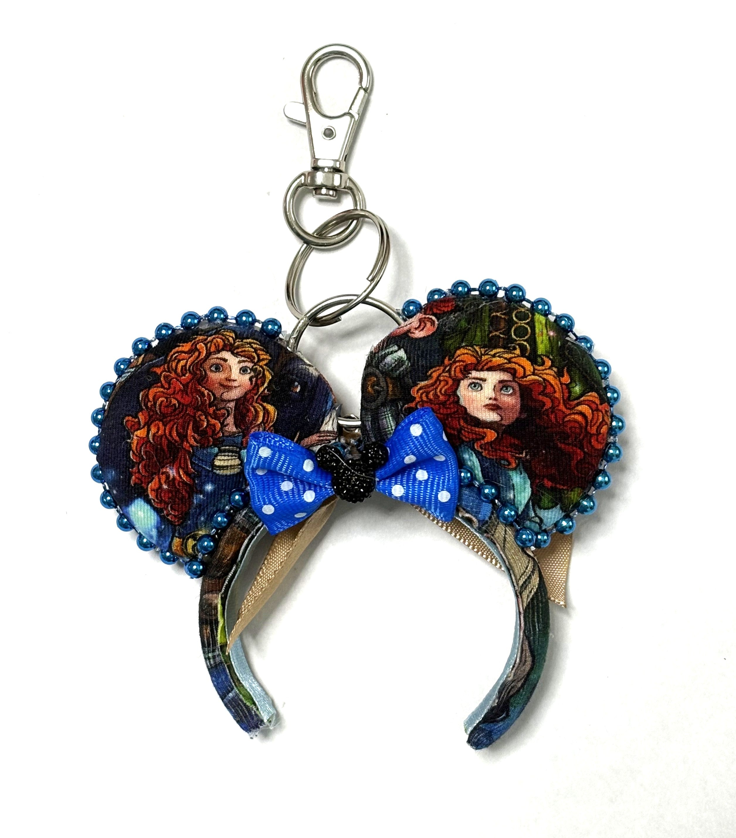 Handcrafted Highland Destiny Mini Magic Charm with Scottish-inspired storybook ears, blue beaded trim, bright-blue polka-dot bow and lobster clasp.