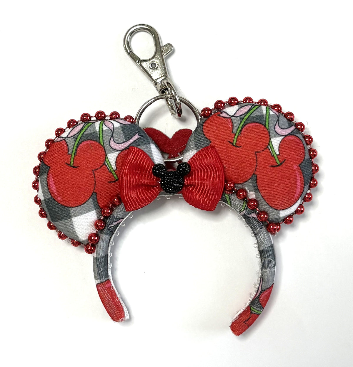 Handcrafted Cherry Belle Mini Magic Charm with black-and-white gingham cherry ears, sparkling red beaded trim, red bow and lobster clasp.