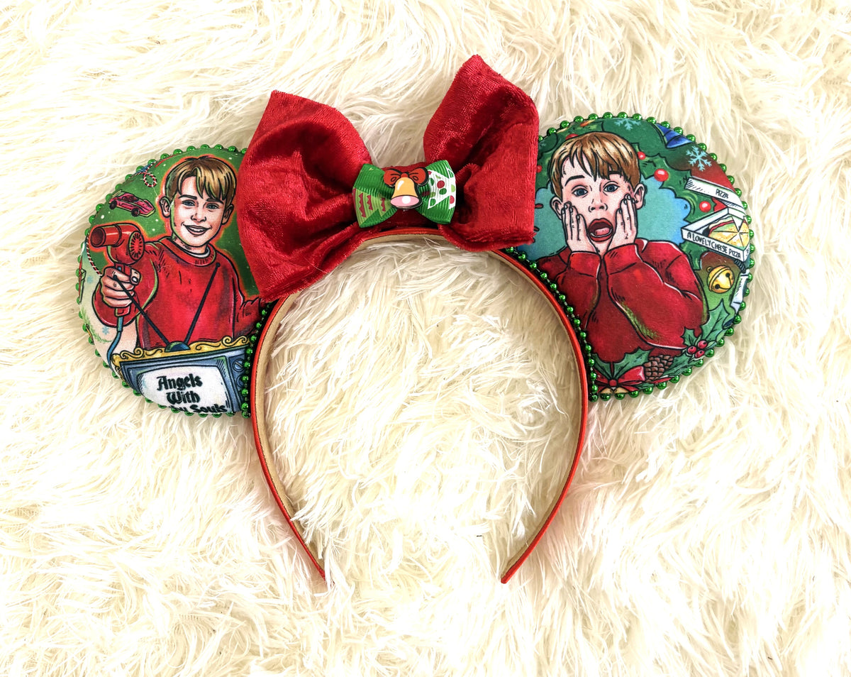 Handcrafted Home for the Holidays Christmas mouse ear headband with holiday comedy-inspired fabric, green beaded trim, red velvet bow and festive bell accent.