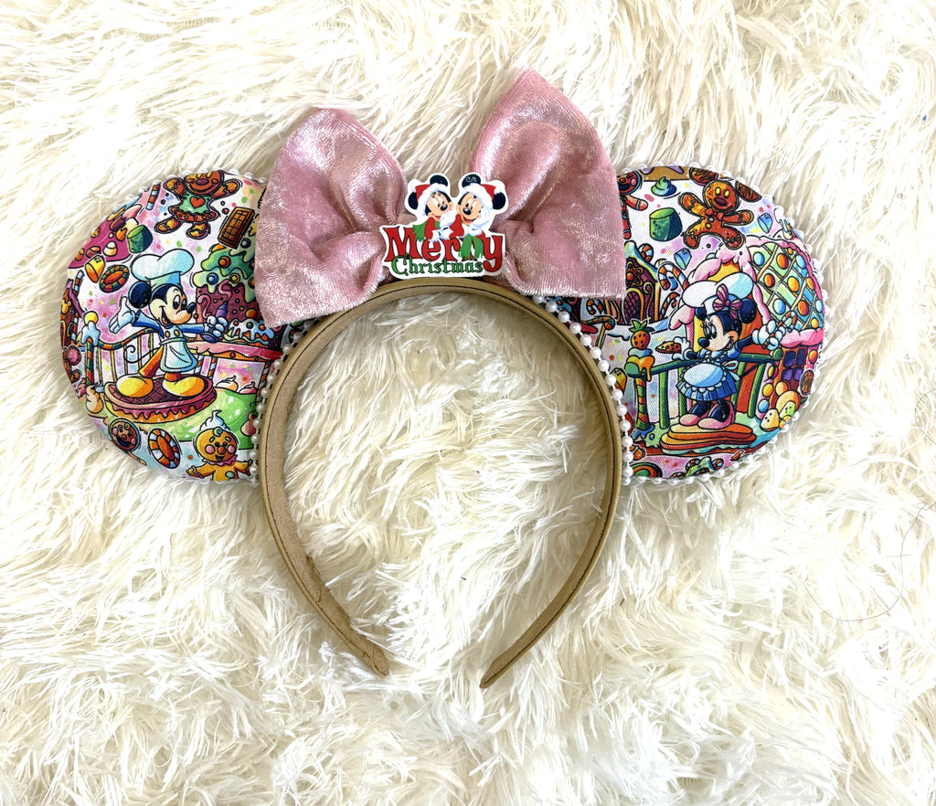 Sweet Holiday Wishes handcrafted mouse ear headband featuring colorful Christmas character fabric, white pearl-beaded trim, oversized pink velvet bow, and Merry Christmas centerpiece.