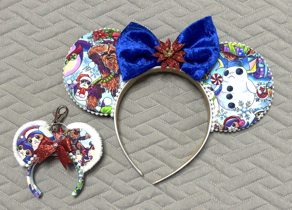 Galactic Holiday Cheer Pixie Pair Set with Christmas space character mouse ears, royal-blue velvet bow, red poinsettia, pearl trim, and matching red-bow mini charm.