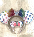 Luxe Spectrum Boutique Pixie Pair featuring a handcrafted multicolor mouse ear headband with rainbow sequin bow, resin mouse centerpiece, and matching mini ear charm.