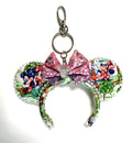 Handcrafted Picnic Pals mini mouse ear bag charm featuring picnic-inspired artwork, a sparkling pink boutique bow, pearl trim, and whimsical park style.